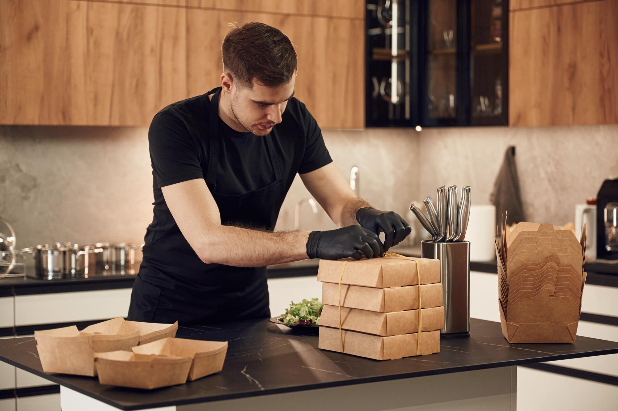 Small portrait of chef arranging boxes