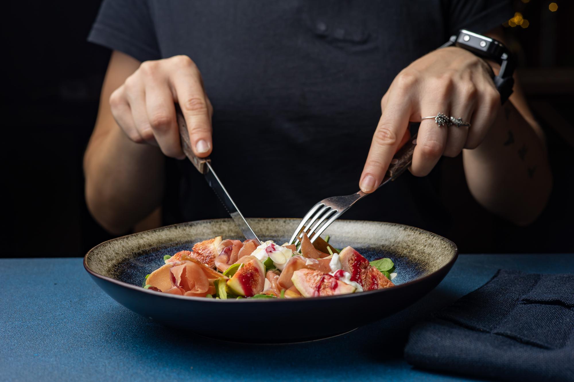Chef preparing portioned gourmet meal in studio